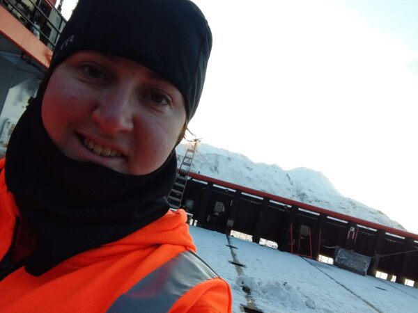 Female mariner working on boat in Alaska.