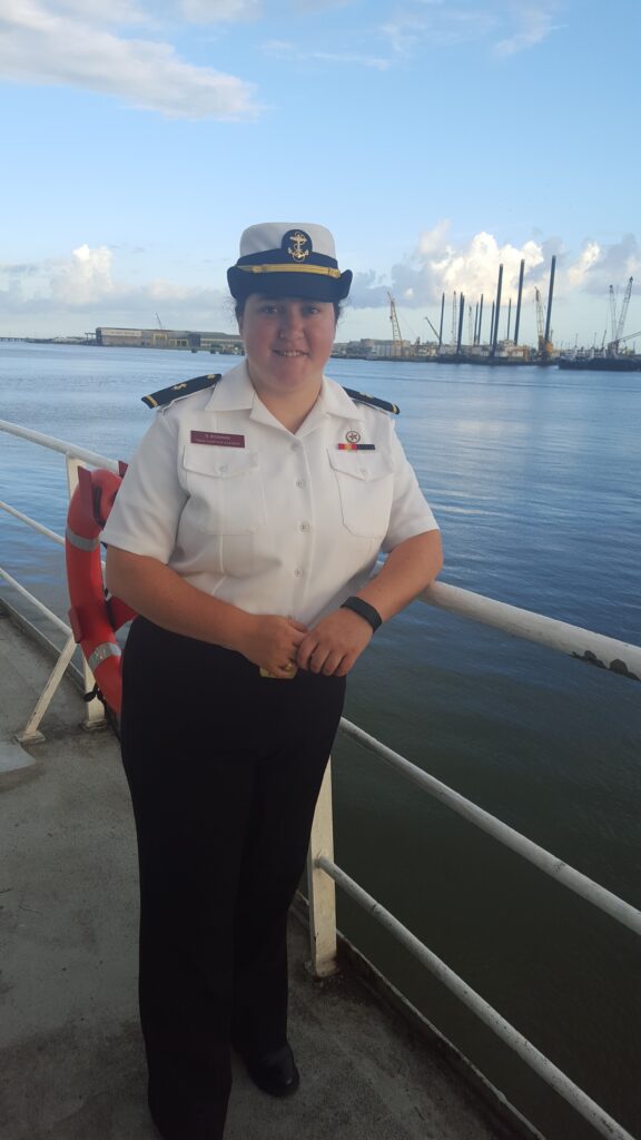 Female student standing onboard ship.