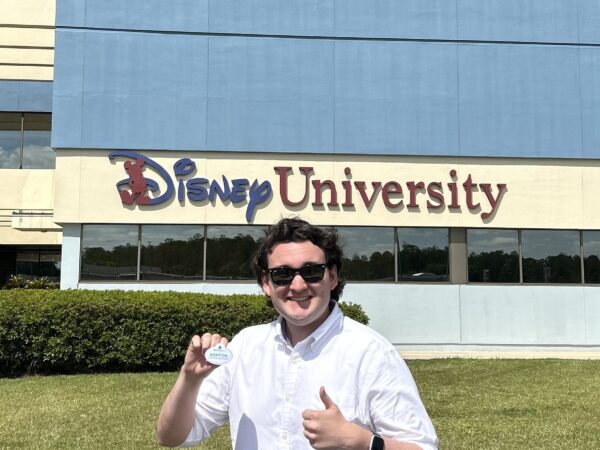 Ashton Whittington in front of the Disney University building