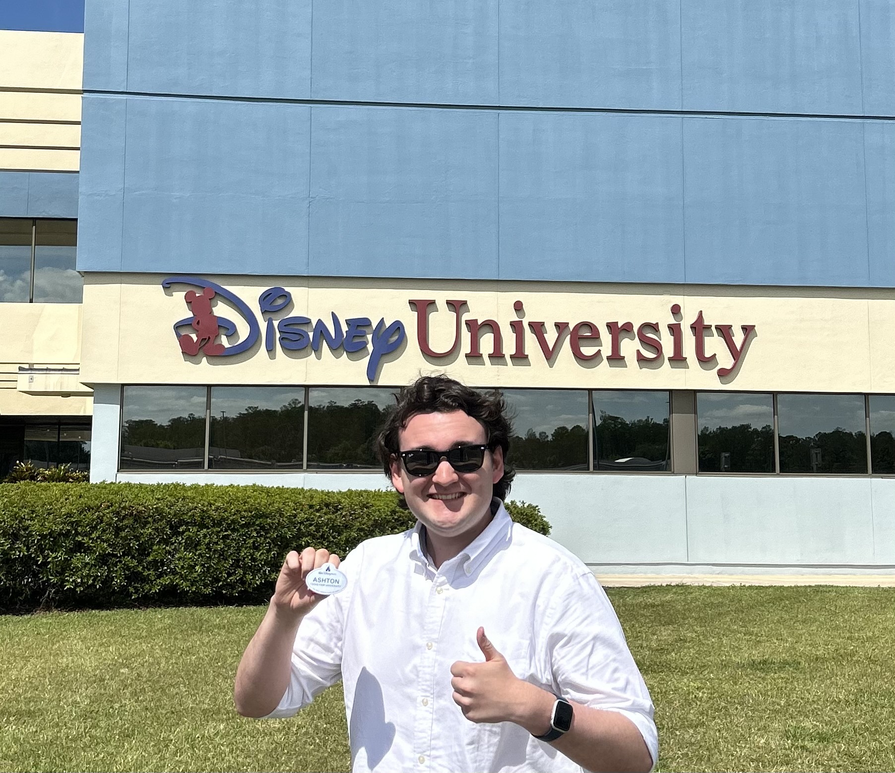 Ashton Whittington in front of the Disney University building