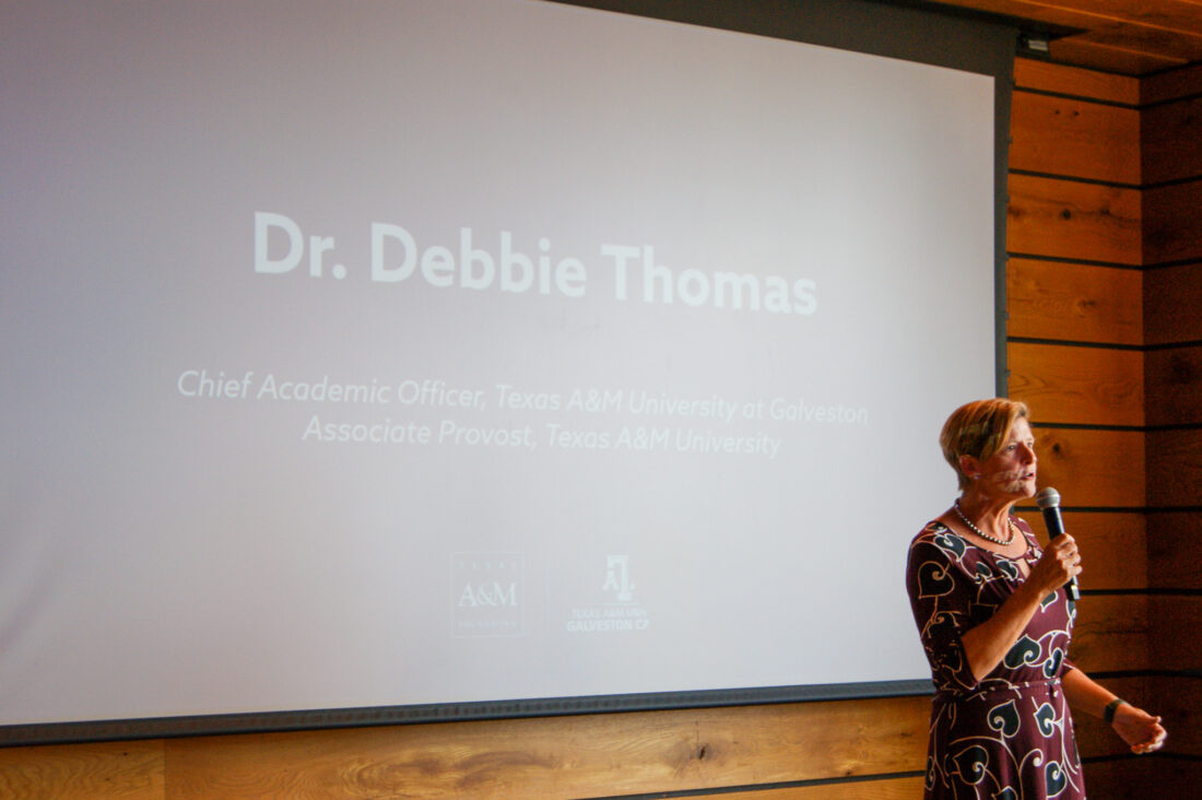 Dr. Debbie Thomas speaking to an unpictured crowd of cadets, former students and supporters in Boston during Summer Sea Term 2024