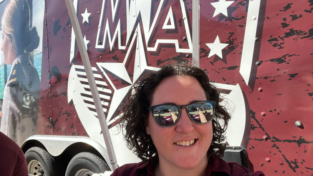 Sarah Bowman ’16 in front of the mobile bridge simulator trailer.