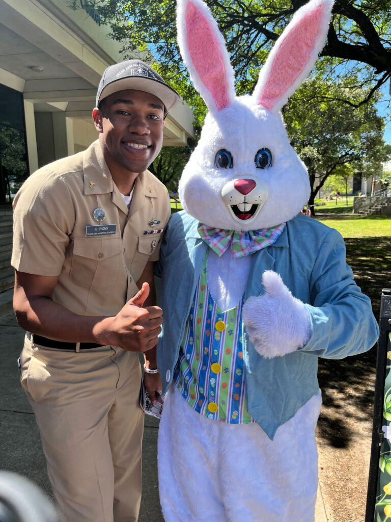 Scott Lyons ’26 standing next to the Easter Bunny.