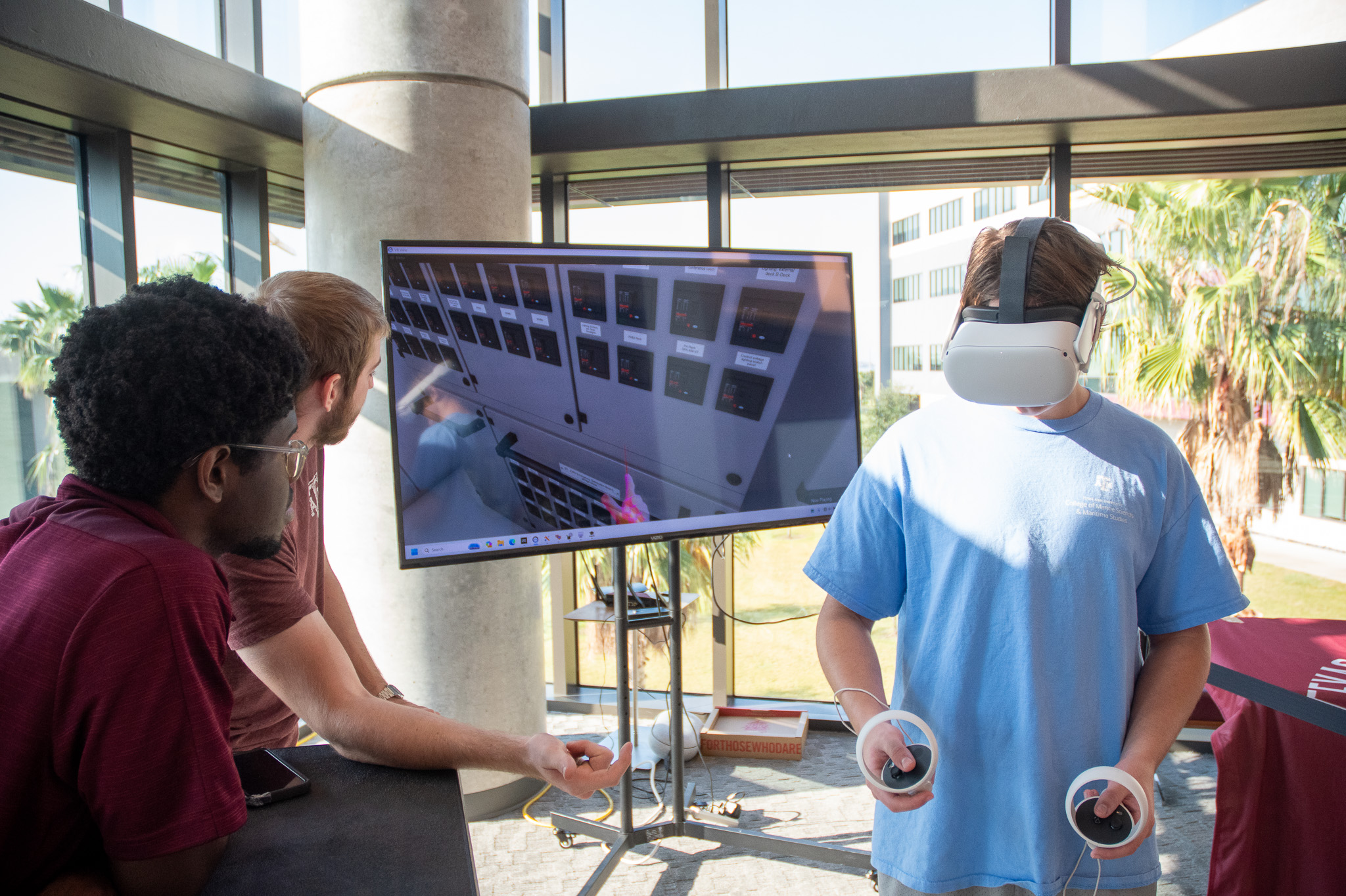 Visitors using virtual reality training technology at Aggieland Saturday by the Sea