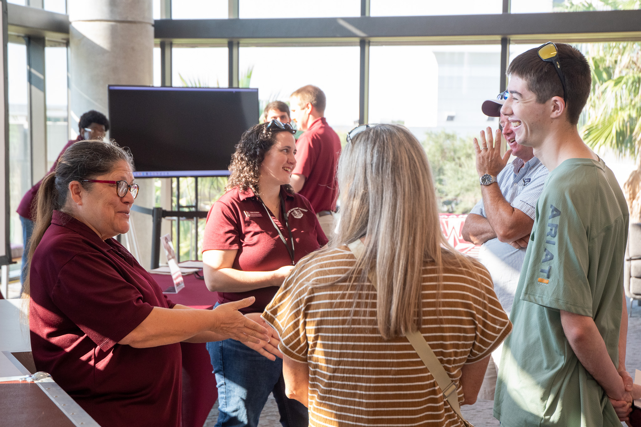 Visitors talking with Texas A&M Maritime Academy staff at Aggieland Saturday by the Sea