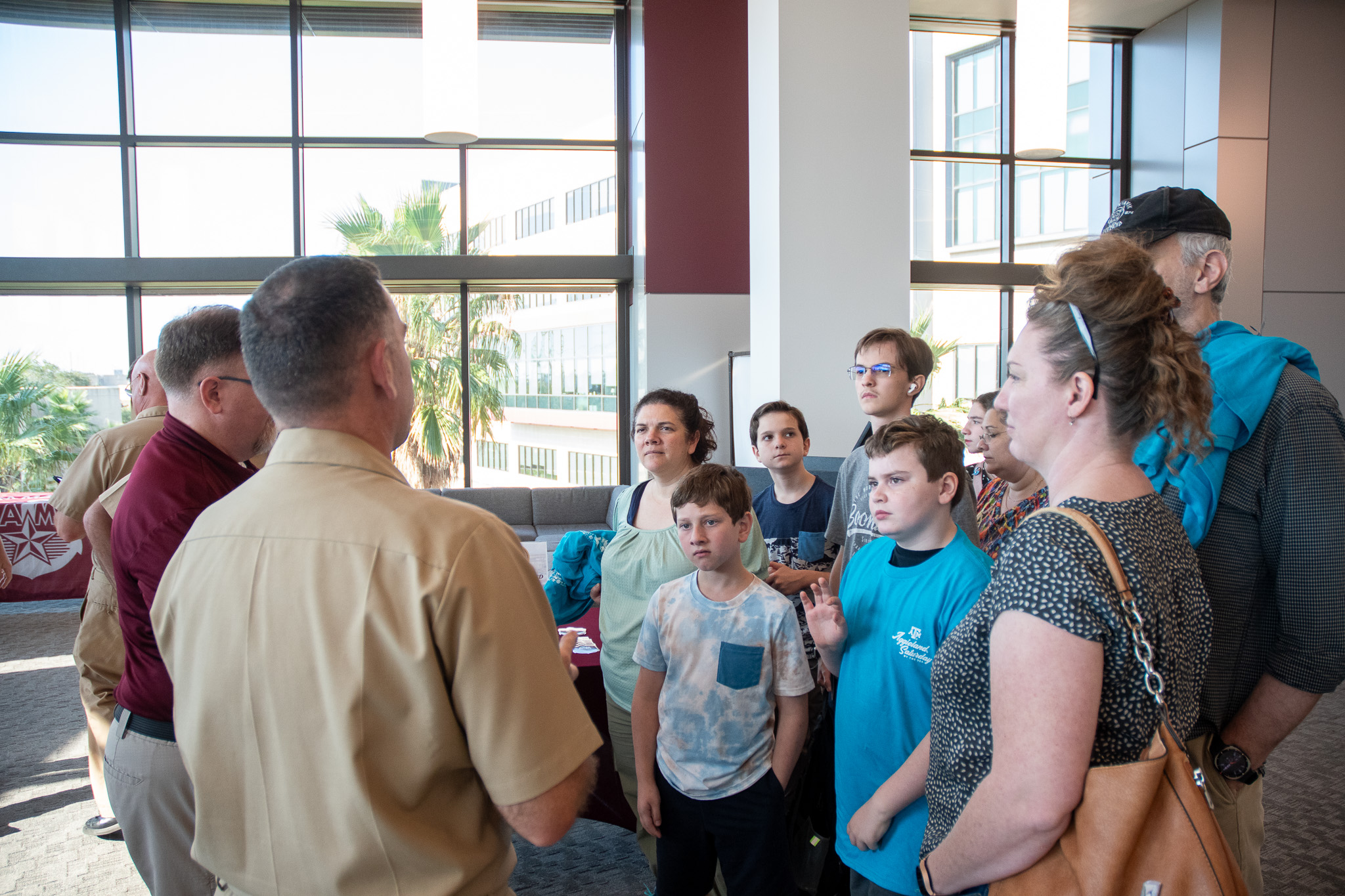 Visitors talking with Texas A&M Maritime Academy staff at Aggieland Saturday by the Sea