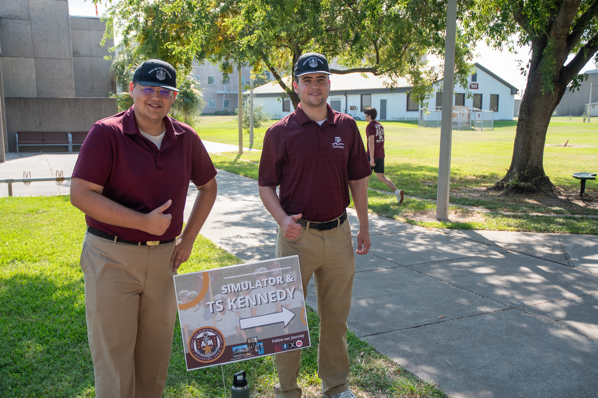 Two cadets assisting with Aggieland Saturday by the Sea