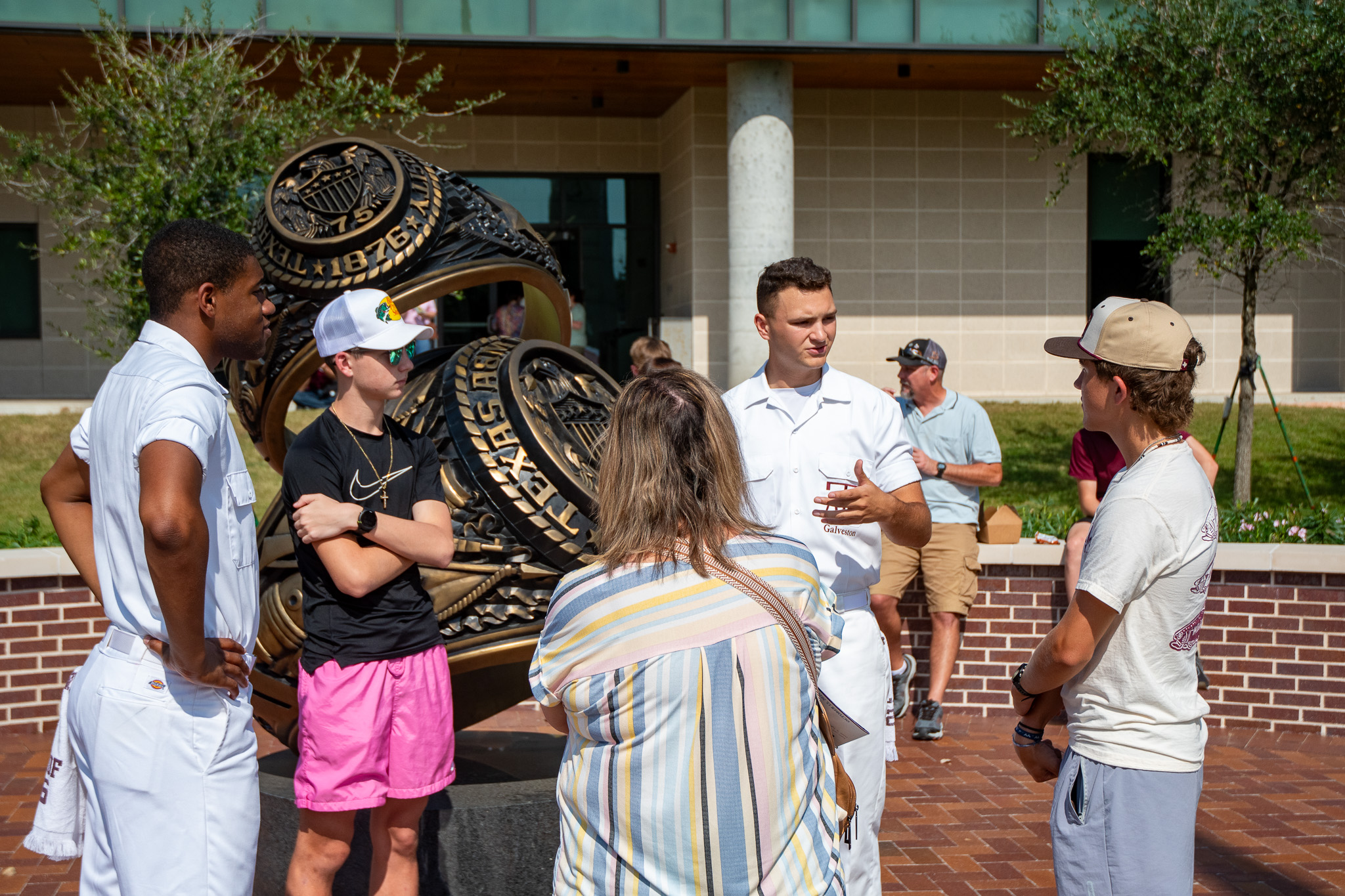 Visitors to Aggieland Saturday by the Sea at the Aggie Ring Statue