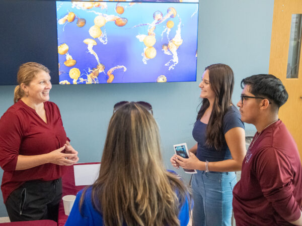 Dr. Jamie Steichen talking with visitors to Aggieland Saturday by the Sea