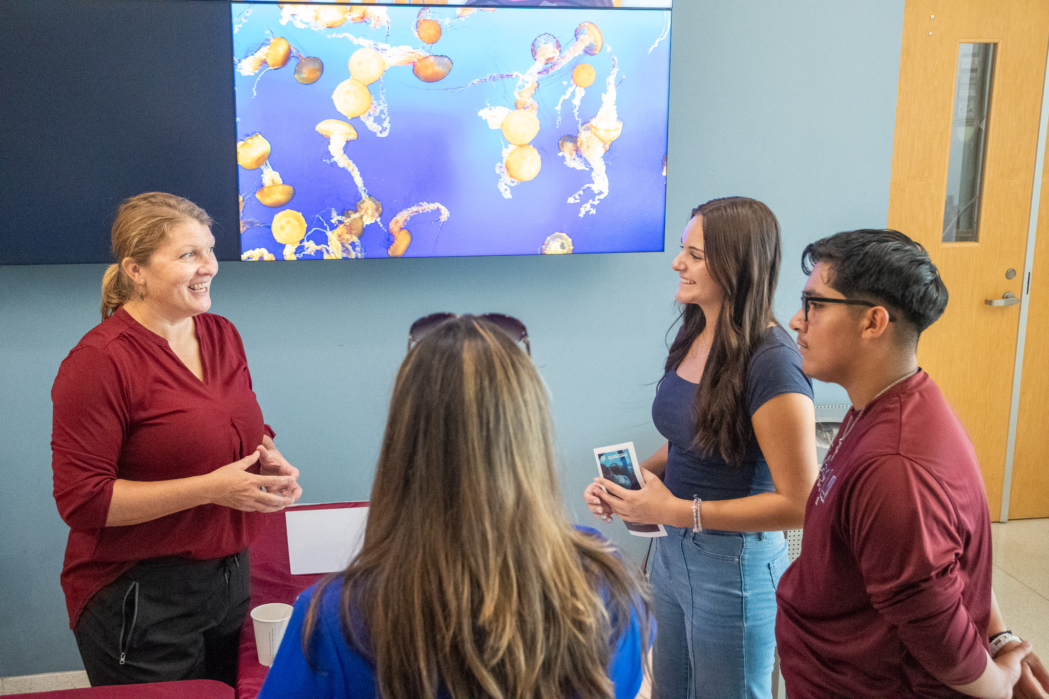 Dr. Jamie Steichen talking with visitors to Aggieland Saturday by the Sea