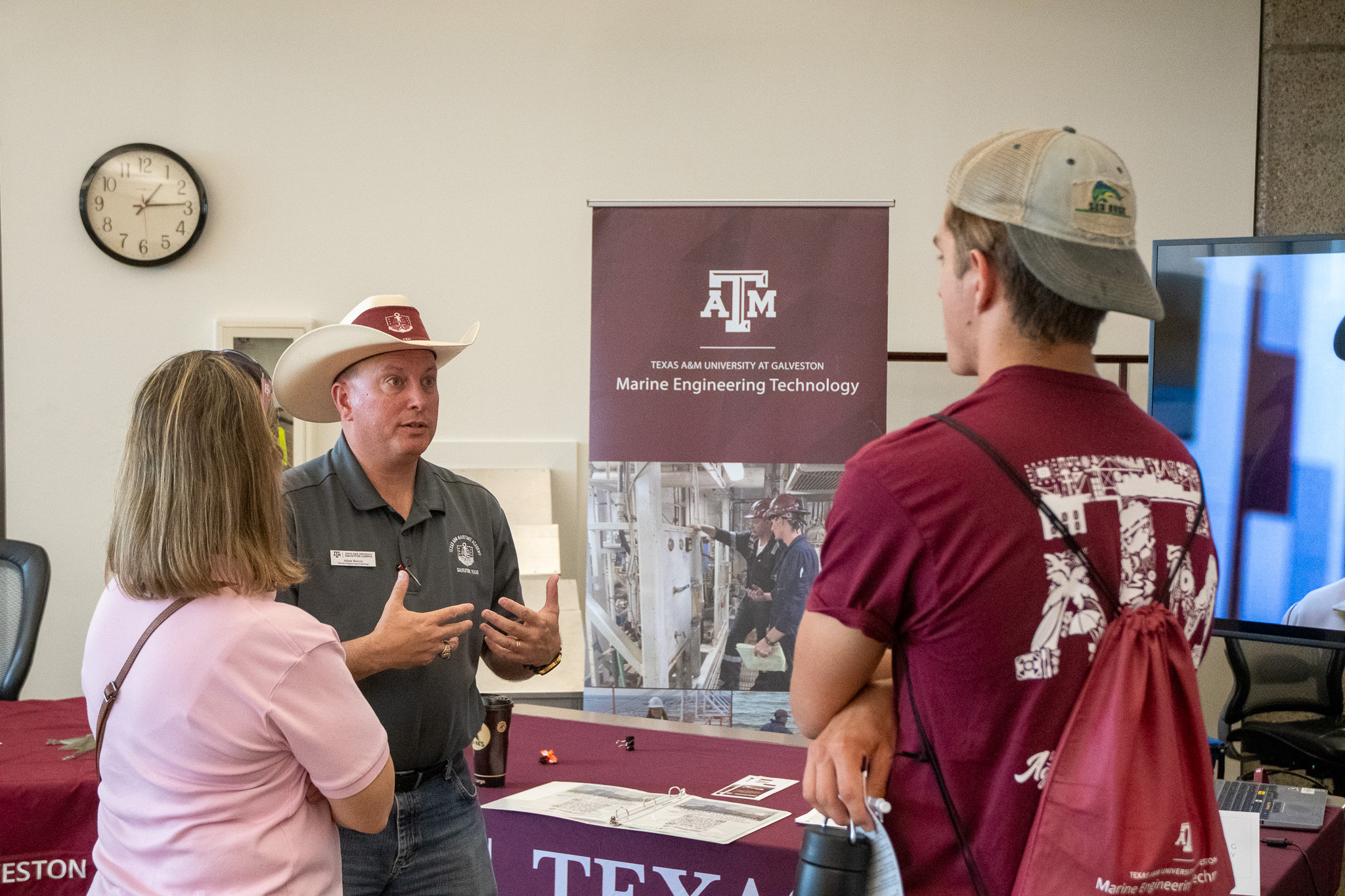 Professor Adam Reeves talks to visitors at Aggieland Saturday by the Sea