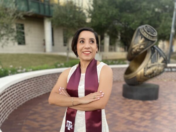 Jossette Chimes standing at the Galveston Campus in front of the Aggie Ring Statue