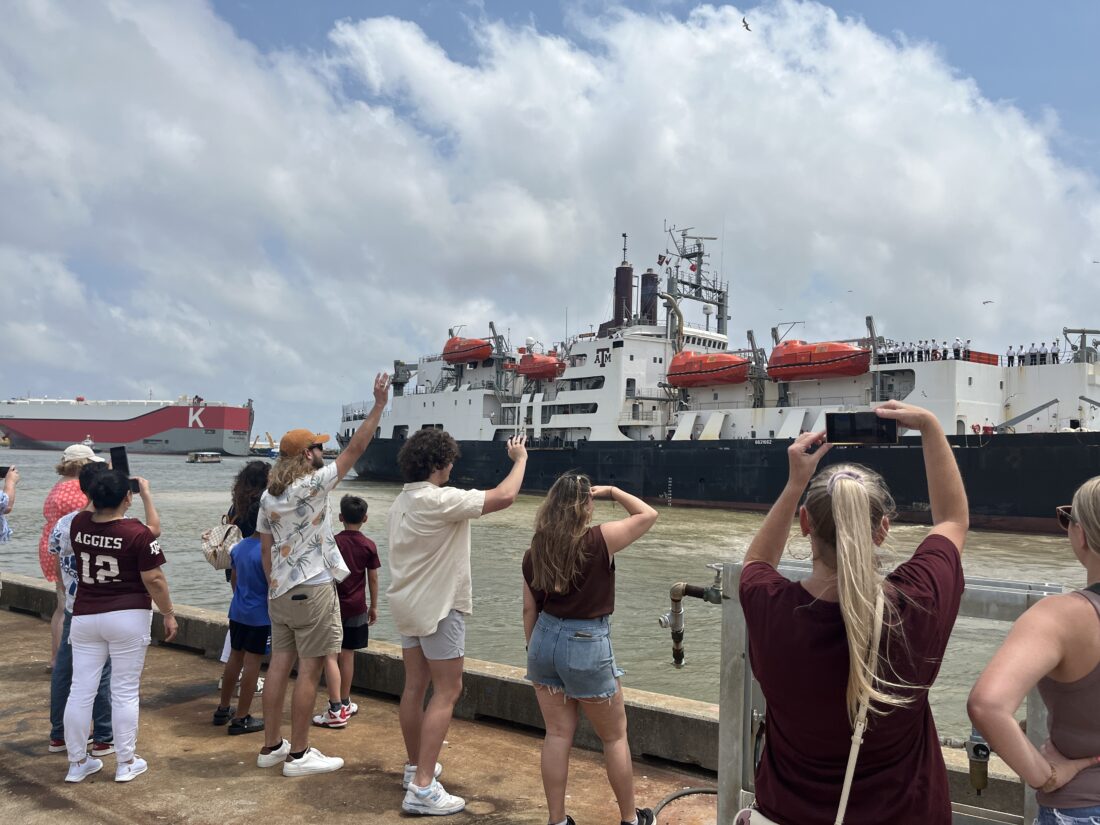 public crowd waving goodbye to TS Kennedy
