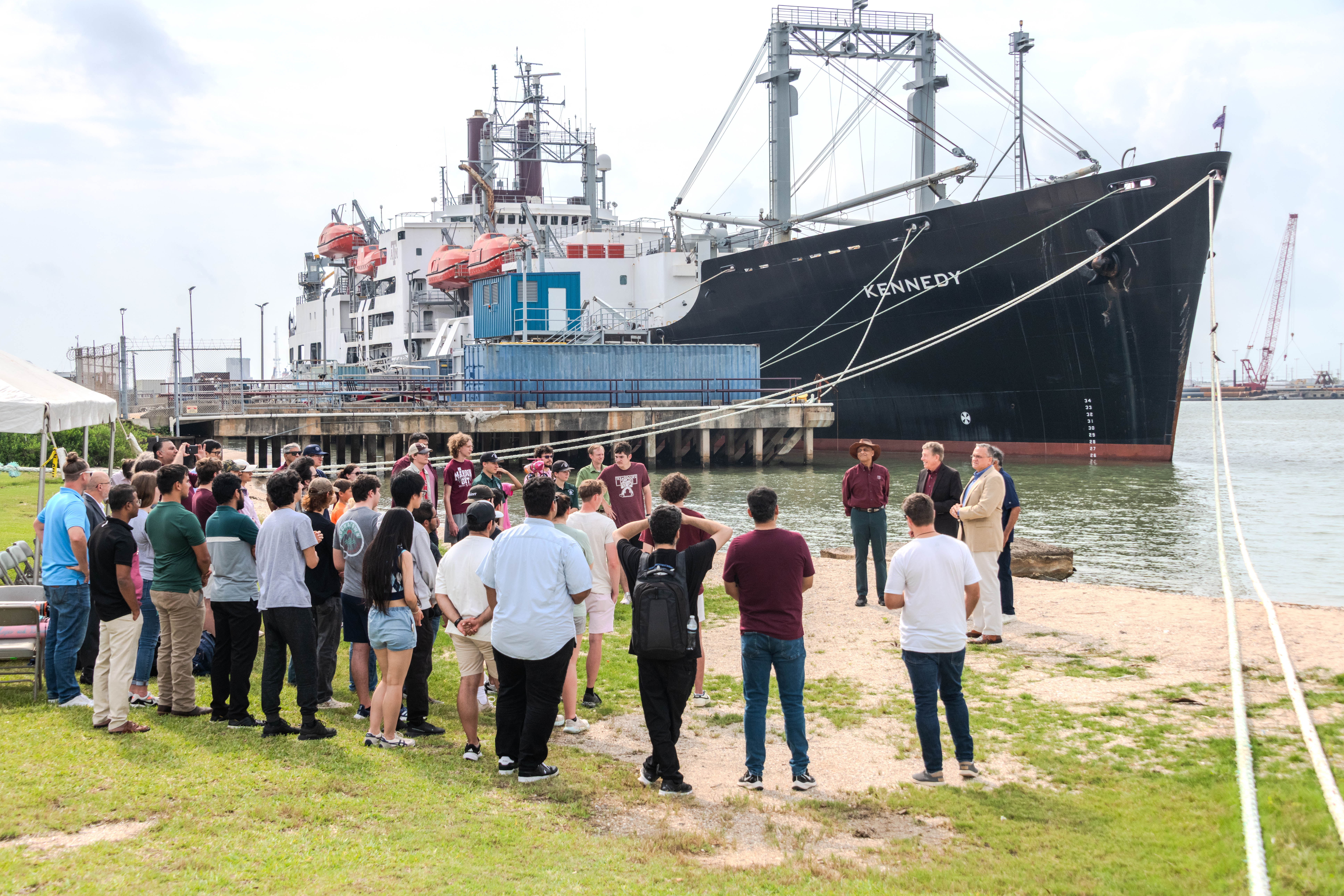 A crowd gathered by the dock at Shell Beach at Texas A&M University at Galveston
