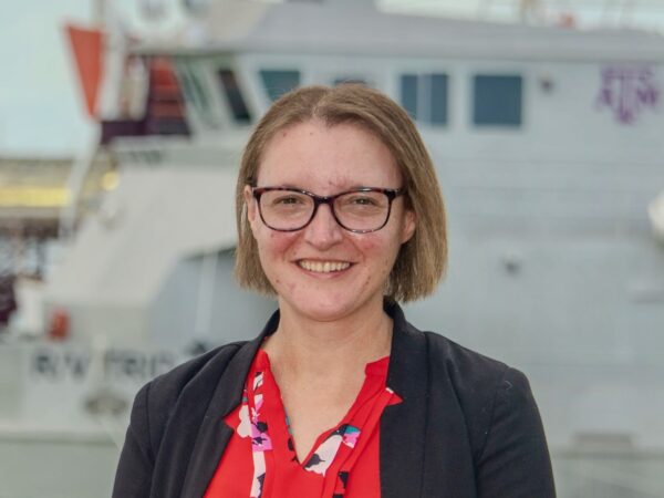 Dr. Jessica Labonté in the foreground with RV Trident in the background